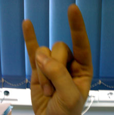 Handzeichen, Kleiner- und Zeigefinger zeigen nach oben.